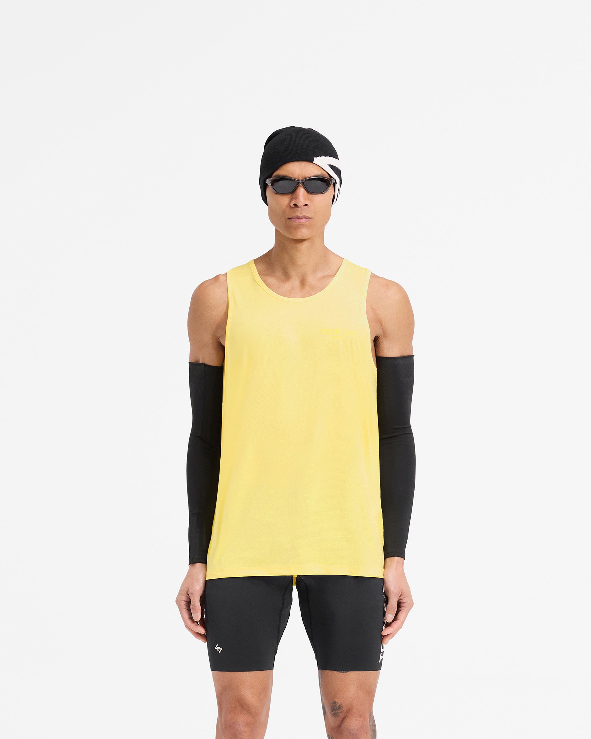 Man wearing a yellow running vest on a plain white background | Team 247 Run Vest in Lemon | Lightweight breathable running vest with moisture wicking | 247 T-Shirts | Represent Clo