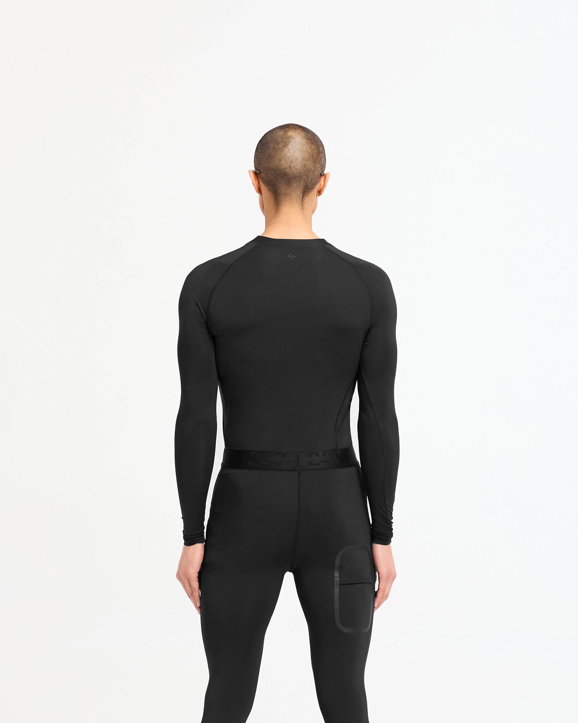 Man wearing a black long sleeve t-shirt on a plain white background | 247 Compound Long Sleeve T-Shirt in Black | Antibacterial quick drying t-shirt with raglan sleeves | 247 T-Shirts | Represent Clo