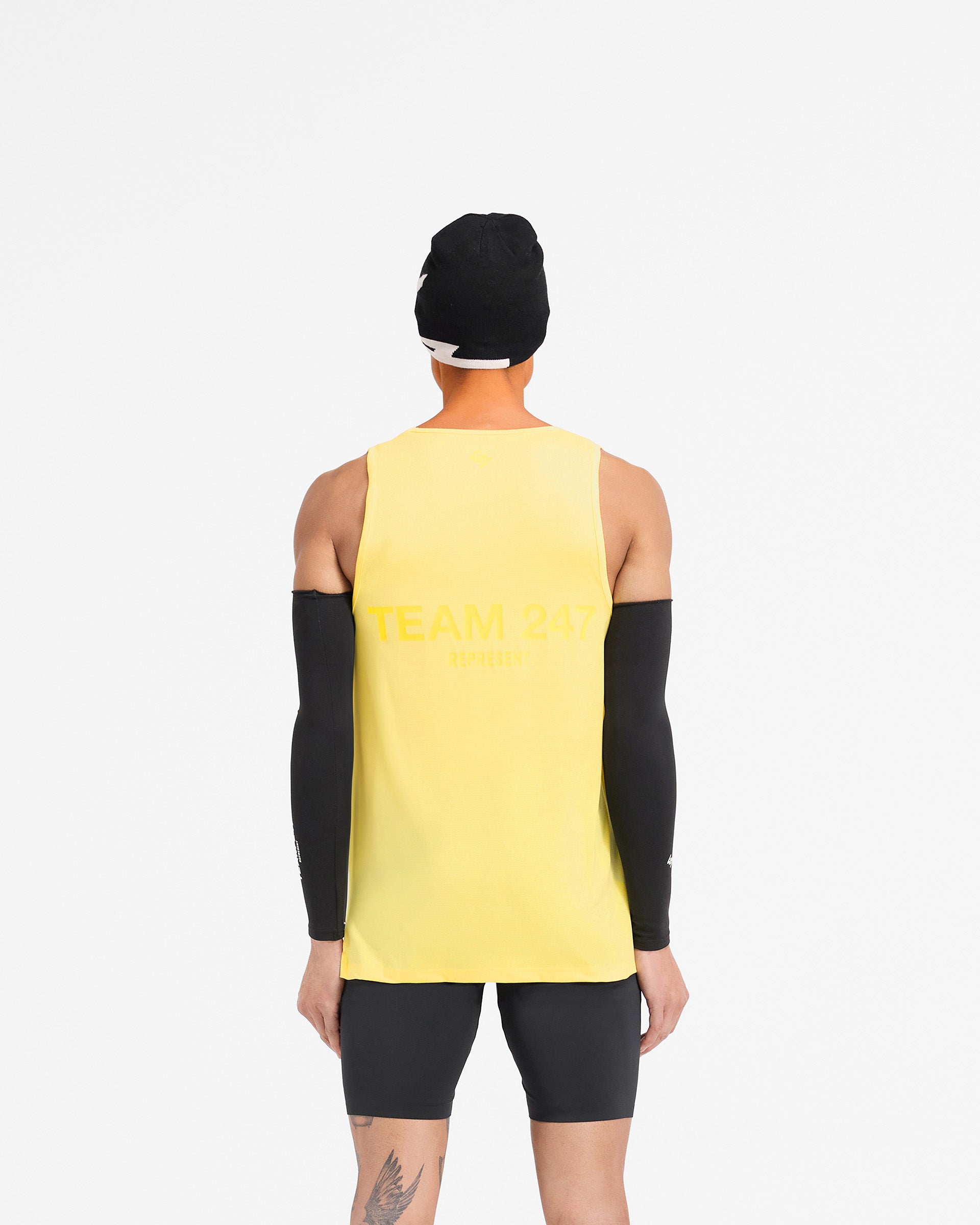 Man wearing a yellow running vest on a plain white background | Team 247 Run Vest in Lemon | Lightweight breathable vest with Team 247 branding | 247 T-Shirts | Represent Clo